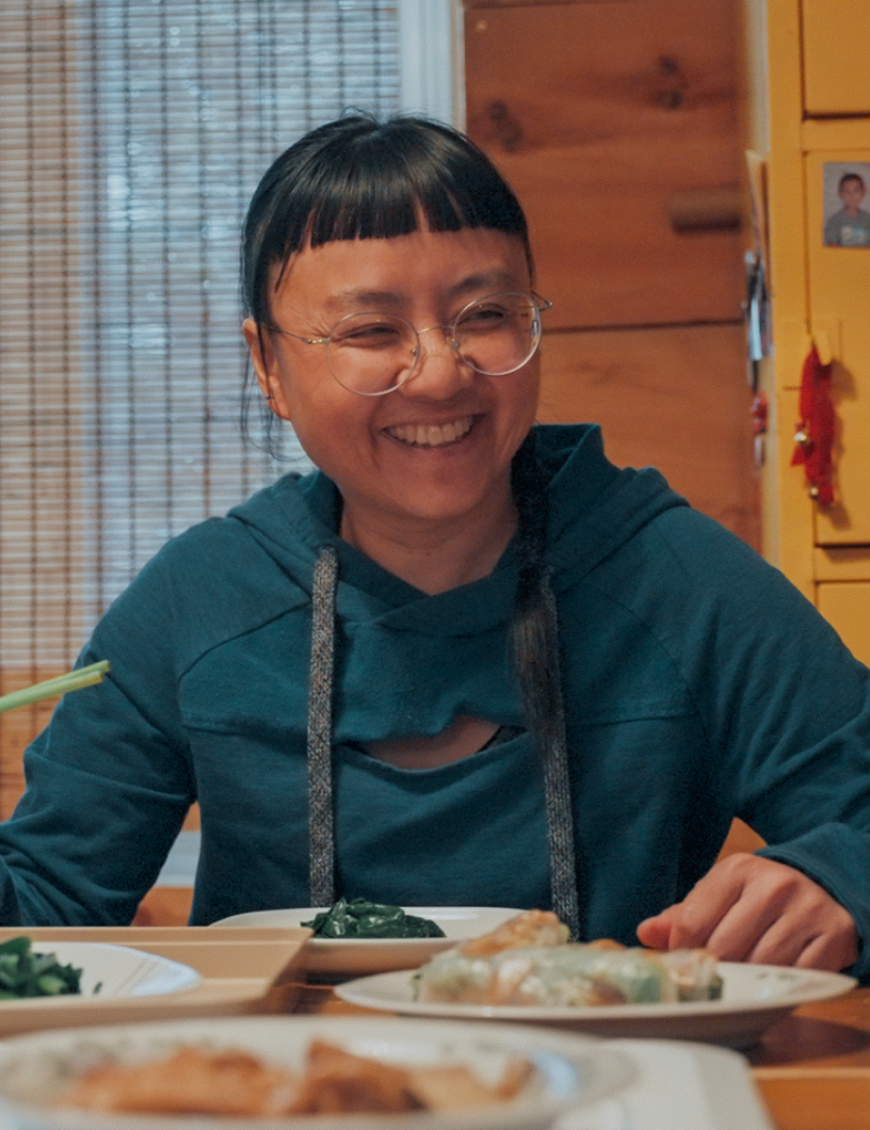 Trâm Nguyên sits at a table.
