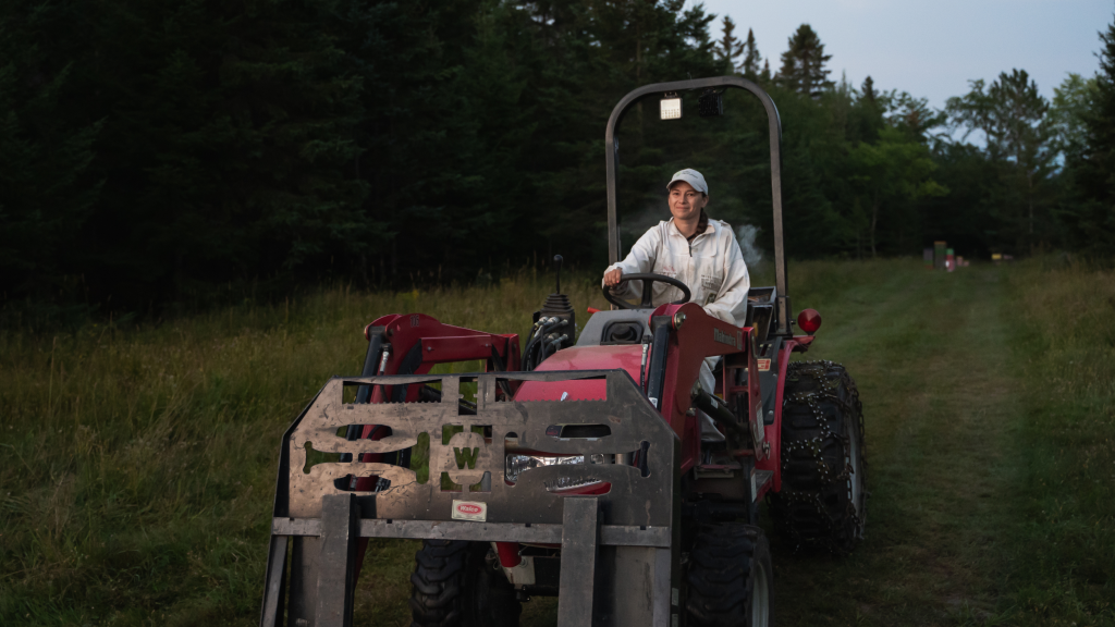 Maggie Lamothe-Boudreau riding a tractor.